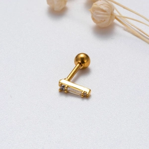 Close-up of gold-plated stud earring with rectangle zircon and screw back ball design