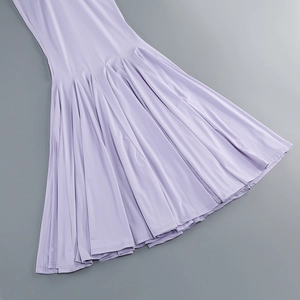 Detail of a purple fishtail dress hem with elegant pleats and high-quality stitching