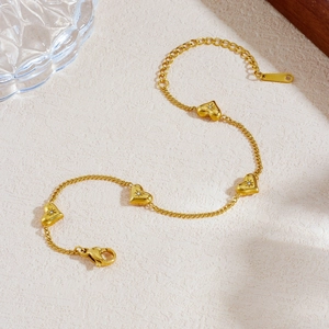 Elegant gold-plated stainless steel bracelet with four cubic zirconia heart charms