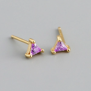 Macro shot of geometric gold earrings with faceted purple triangular zircon stones