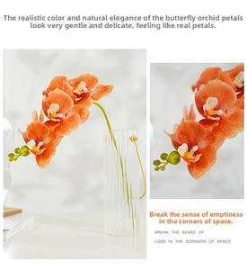 Detailed close-up of vibrant coral orange artificial orchid petals with natural texture