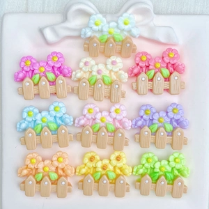 Colorful resin flower fence accessories in ten vibrant shades on a white decorative tray