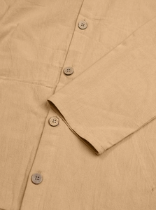 Detail of khaki cotton linen fabric texture and rustic wooden buttons on long sleeve shirt