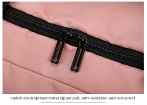 Macro shot of durable black dual zippers on pink nylon fabric for travel bag