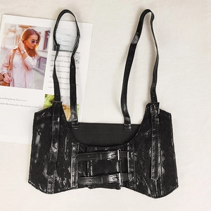 Close-up of black floral lace corset vest with faux leather straps and double buckles
