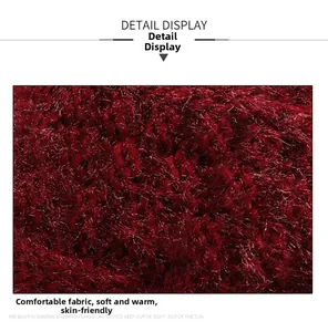 Macro view of deep red knitted fabric showing soft texture and cozy thermal properties