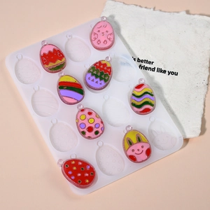 Detail of Easter egg silicone mold and resin pendants with bunny and chick patterns