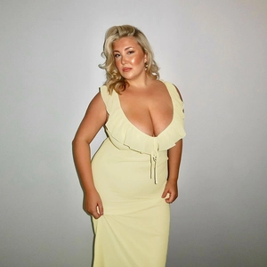Detailed view of the ruffle design and elastic fabric on this light yellow dress