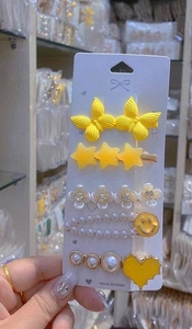 Five-piece yellow butterfly hair clip set with star and pearl heart shapes on card