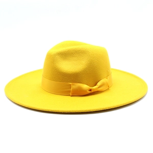 Detail of wide brim wool jazz hat in bright yellow with a matching satin ribbon band
