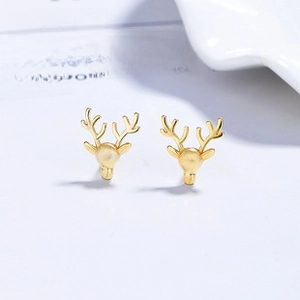 Detailed macro view of S925 sterling silver golden reindeer stud earrings with matte finish