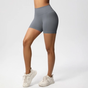 Close-up of seamless high-waist grey fitness shorts with peach lift and quick-dry texture