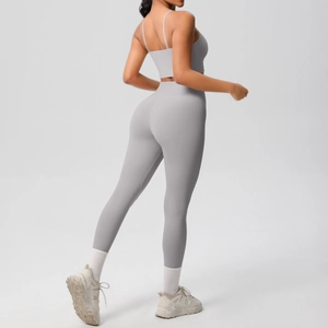 Side view of gray two-piece yoga set featuring thin strap top and high-waist leggings