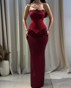 Détails d'une robe bustier bordeaux ornée de strass brillants et d'une coupe sirène ajustée