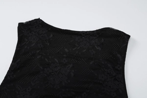 Detailed close-up of the black lace V-neckline and hollow weaving on the summer dress