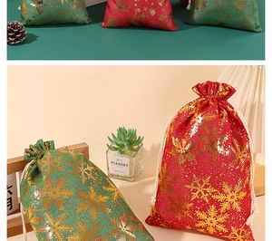 Detail of red and green cotton Christmas drawstring bags with gold snowflake foil patterns