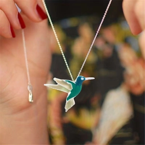 Elegant hummingbird necklace with green enamel pendant and silver chain for women