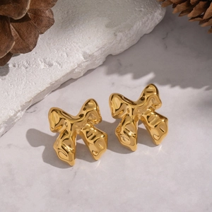 Elegant gold bow-knot stud earrings with liquid metal texture on white stone base