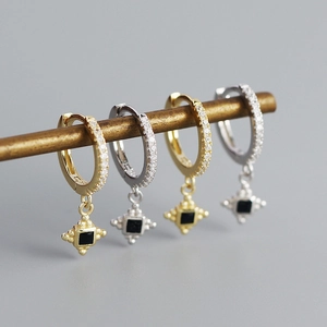 Close-up of s925 silver hoop earrings with black square gem and star charms