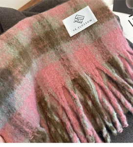 Close-up of pink and brown checkered cashmere-feel scarf with tassel fringe details