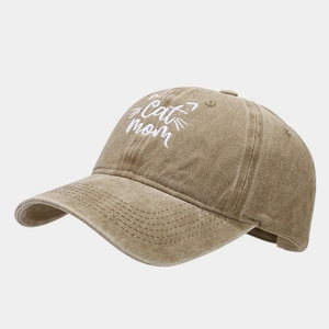 Detailed close-up of white Cat Mom embroidery on a khaki washed cotton baseball cap