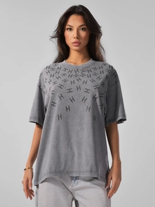 Detailed view of washed grey cotton t-shirt with rhinestone H-letter pattern design