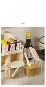 Close-up of double-tier kitchen spice rack with transparent jars and small spoons