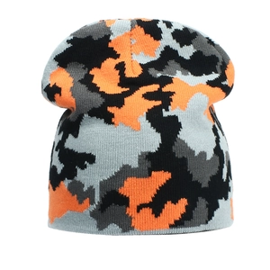 Close-up of winter knit beanie showing vibrant orange camouflage pattern and texture