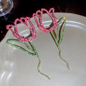 Detail of tulip earrings with pink and green rhinestones and elegant hollow metalwork