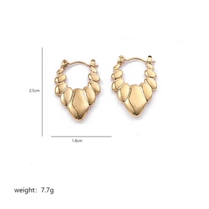 Detail view of irregular gold ribbed earrings showing dimensions 2.5cm height and 1.8cm width