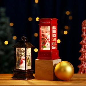 Christmas lanterns with Santa and snowman scene on a cozy warm wooden table