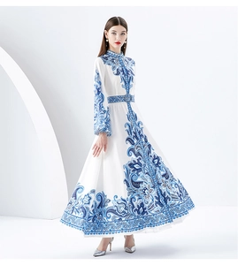 Full view of long floral dress with vintage blue patterns and a high waist belt