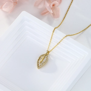 Elegant gold leaf pendant necklace featuring sparkling cubic zirconia stones and link chain