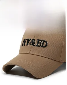 Close-up of khaki baseball cap featuring 3D embroidered NY&ED letters and twill texture