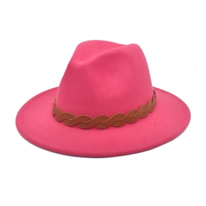 Detailed texture of rose red wool fedora hat featuring a brown braided leather band