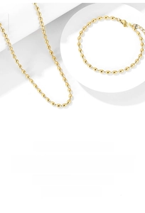 Detail view of gold beaded jewelry set featuring oval beads necklace and bracelet links