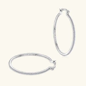 Macro shot of silver hoop earrings with pavé-set white cubic zirconia stones