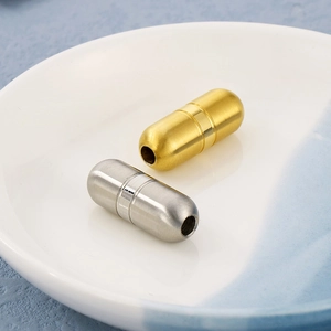 Detailed macro of gold and silver capsule-shaped vacuum plated stainless steel spacers