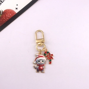 Detailed view of cute Christmas cat metal keychain and candy cane bag pendant accessory charm.