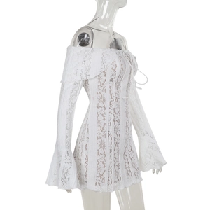Detail of floral lace texture and flared cuffs on a white off-shoulder bodycon dress