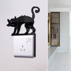 Sleek black acrylic cat mirror wall sticker as decorative decal above a home light switch