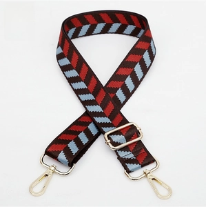 Detail of jacquard woven geometric strap with adjustable gold tone hardware buckles