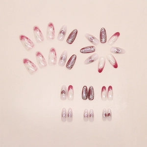 Detail of pink and purple press on nails with silver heart relief and star patterns