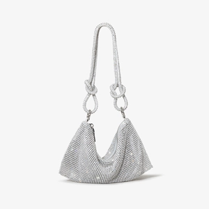 Detail of silver rhinestone handbag with sparkling crystal knots and luxury finish