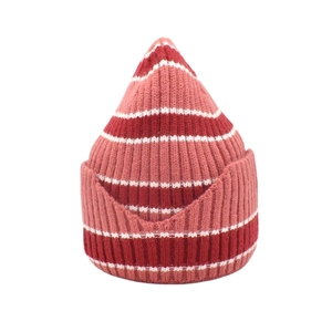 Detail of red, pink, and white striped knit beanie with pointed top and wavy hem texture