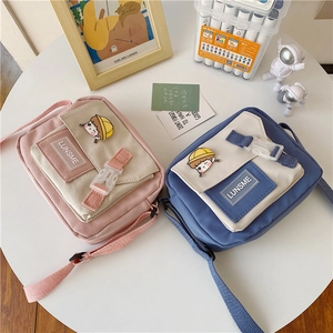 Japanese style nylon crossbody bag with cute girl brooch and contrast pocket detail