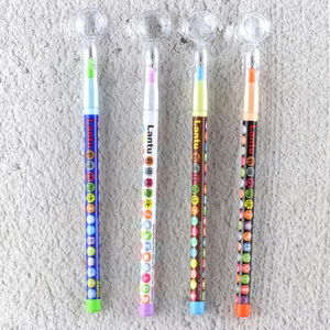 Detail of four colorful plastic ballpoint pens with clear dome caps and printed icons