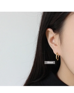 Close-up of 18mm gold plated S925 sterling silver hoop earrings on model ear