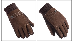 Macro detail of brown suede motorcycle gloves with white stitching and knit cuffs