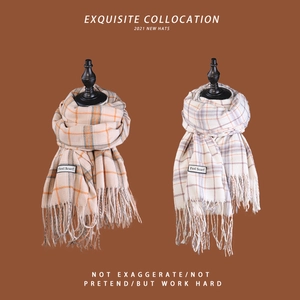 Detail of plaid tassel scarves with soft brushed texture and sewn brand label